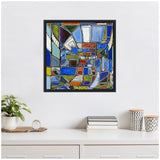 Framed abstract painting by Leah Nadeau featuring geometric shapes in blue, green, orange, brown, and white, hanging above a white sideboard with plants and books.