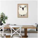 Minimalist sheep illustration with cream wool and black face on beige background, framed and hanging above a wooden dining table with white chairs and cushioned bench.