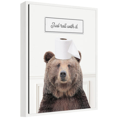Framed canvas art titled Sylvie Bear Just Roll with It Bathroom by Amy Peterson showing humorous bear illustration.