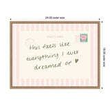 Rectangular framed print resembling a vintage postcard with pink vertical stripes and handwritten text saying 'this feels like everything I ever dreamed of' with a green heart and a rose stamp.