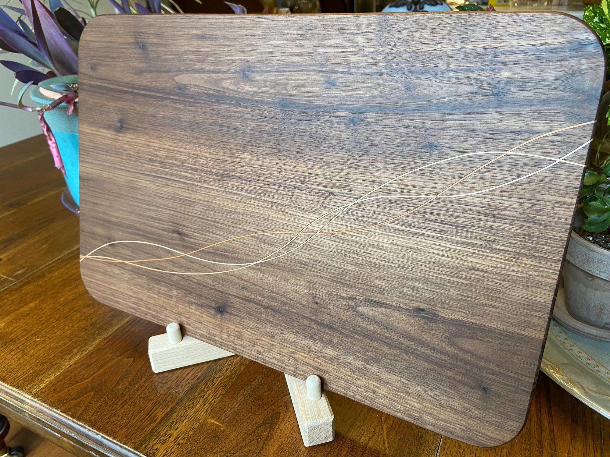Handcrafted walnut charcuterie board with cherry and maple decorative banding