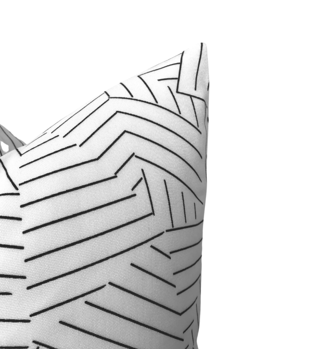 Corner view of a white pillow cover with an abstract black stripe pattern forming angular and segmented lines.
