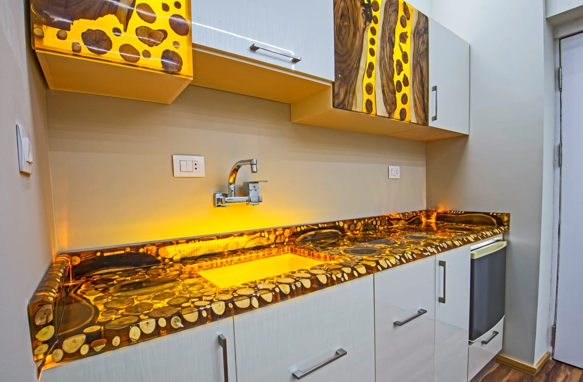 Modern kitchen with a unique countertop design featuring embedded stones.