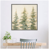 Abstract painting of three evergreen trees in soft green and beige tones, framed and hanging above a light wooden desk with a plant and decorative orb.