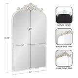 Rectangular mirror 30.75" tall and 19" wide with an antique white frame, arched top, and ornate crown detail at center, shown with keyhole hanger on reverse.