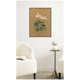 Framed canvas print of Odilon Redon's 1916 Cyclamen featuring pink flowers and green-blue leaves on a brown background, hung above a small round table with a white vase between two cream armchairs.