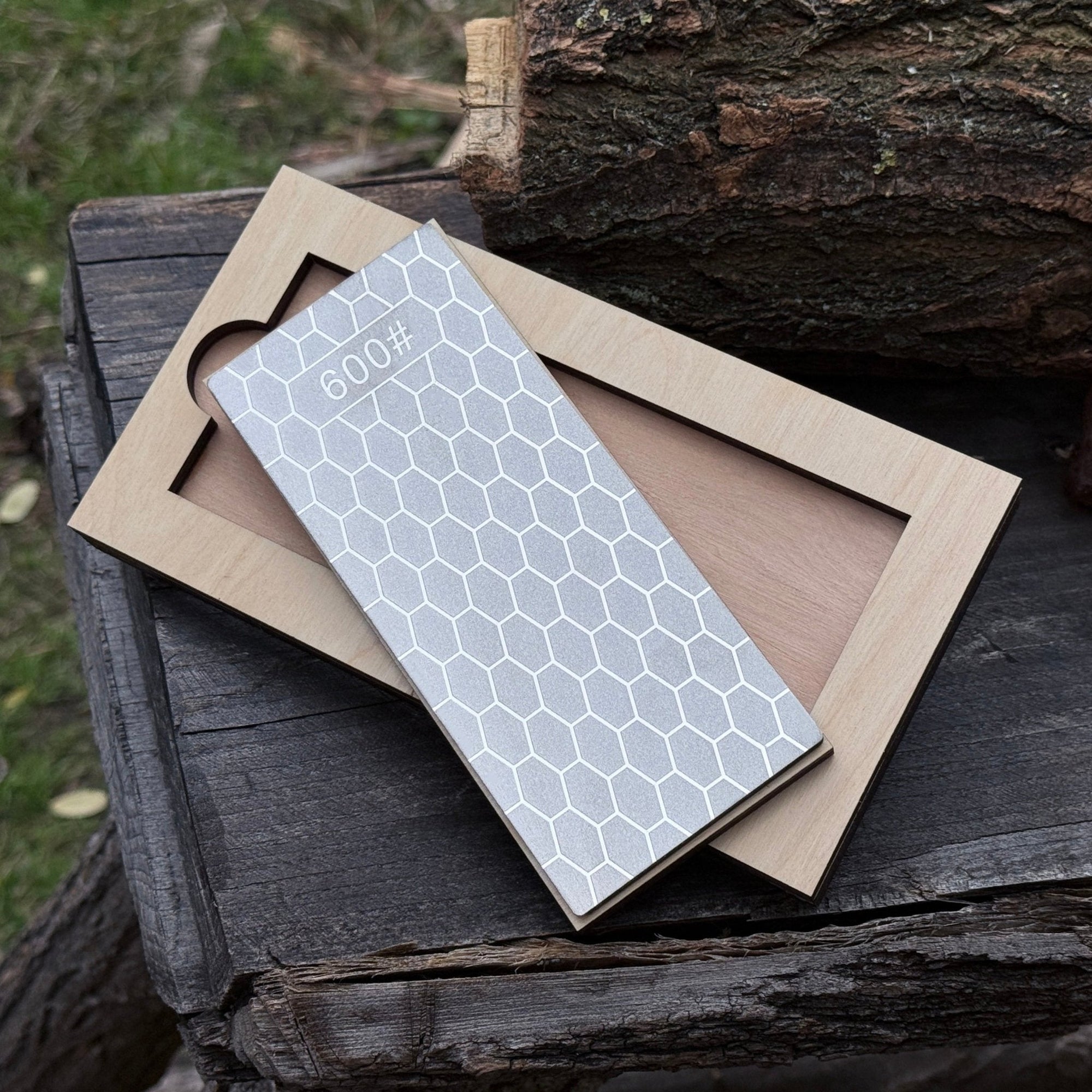 Diamond sharpening stone with 600 grit surface on a wooden ash stand for sharpening knives and tools