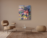 Colorful impressionist painting of a vineyard landscape with red-roofed buildings, green trees, and rolling hills hanging above a minimalist beige living room setup.