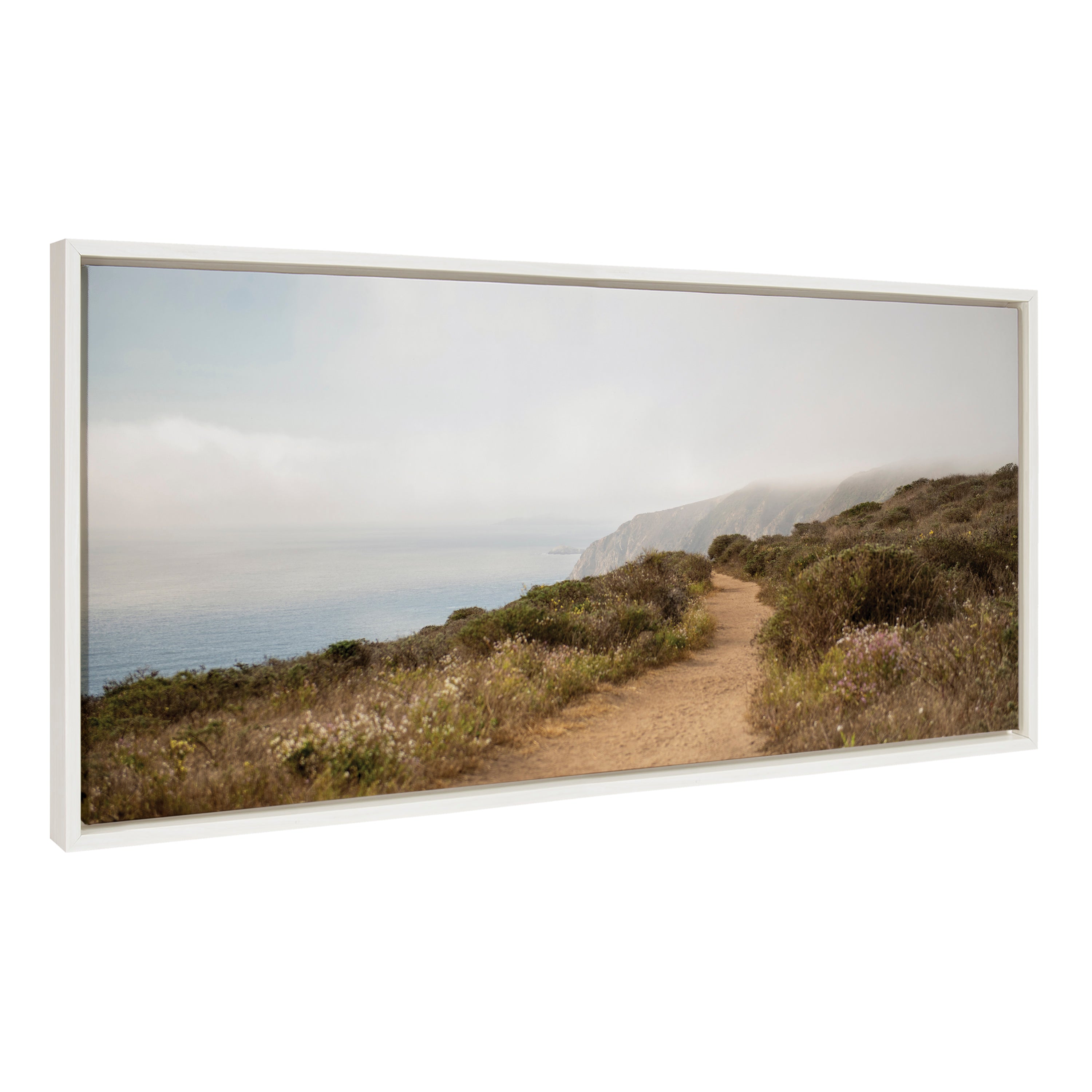 Framed canvas art depicting a coastal scene with waves crashing on rocky shores
