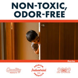 Young child peeks curiously from behind a partially open wooden door in a warm-lit room, emphasizing a non-toxic, odor-free product environment.