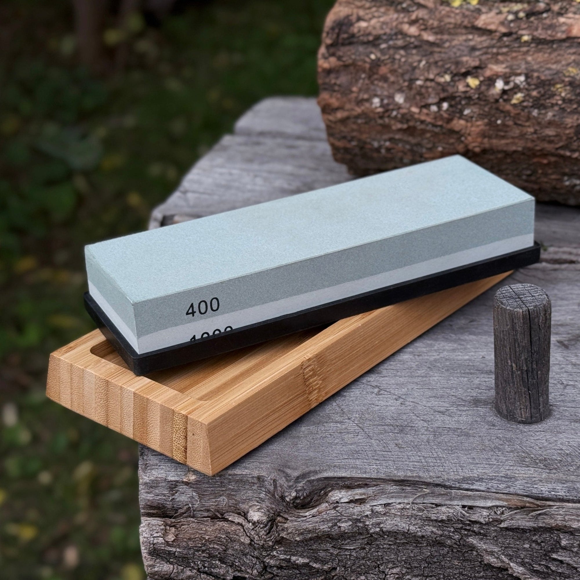 Double-sided sharpening stone with coarse #400 and medium #1000 grit, shown with optional wooden stand