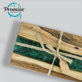 Rectangular wooden board with a glossy, deep green resin river running through the center, tied with natural fiber string and a blank brown tag on light gray background.