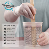 Two hands wearing gloves stirring clear epoxy resin in a plastic measuring cup marked with mixing ratios, with step-by-step instructions visible nearby.