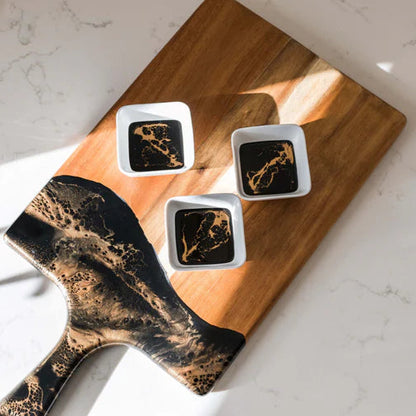 Wooden resin charcuterie board with abstract design on a marble surface