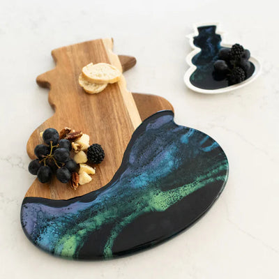 Snowman Resin Charcuterie Board with colorful resin design on acacia wood, displayed on kitchen counter