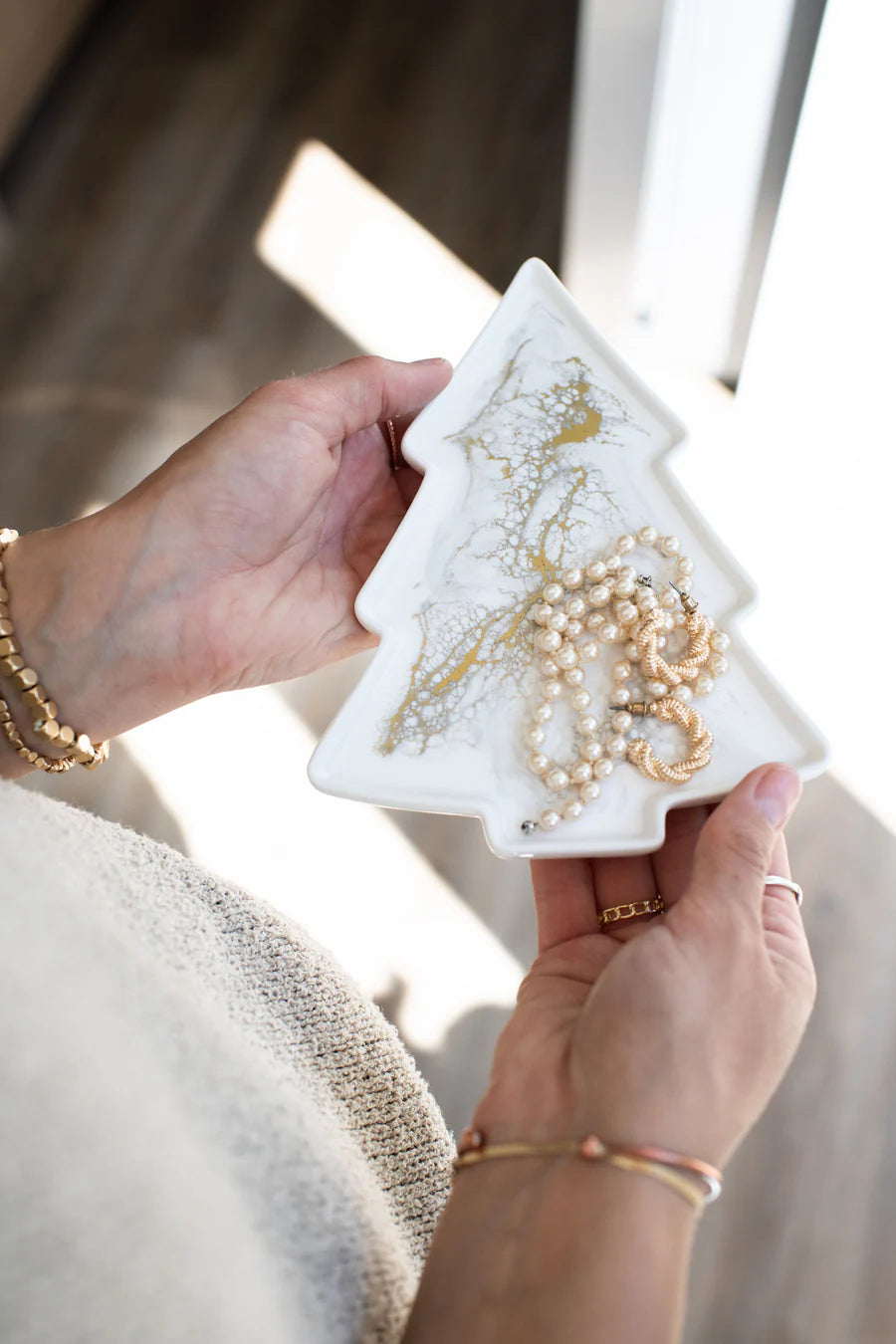 Tree Resin Ceramic Tray a white jewelry organizer with gold and pearl necklaces.