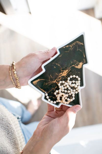 Tree Resin Ceramic Tray a black and gold marbled phone case with a pearl necklace inside.