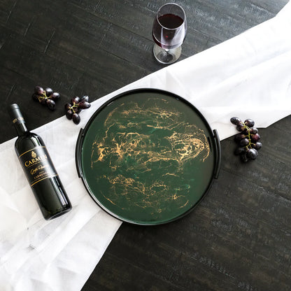 Green resin tray with a bottle of CARMON wine and grapes on a dark surface.