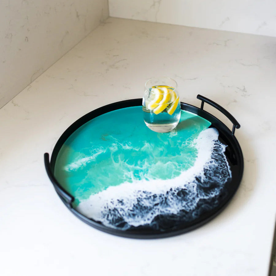 Decorative resin tray with ocean wave design on a countertop