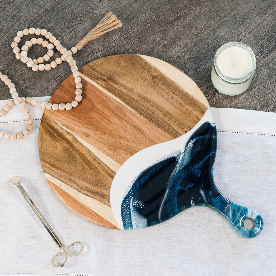 Wooden Cheese Paddle Acacia Serving Charcuterie Board with a blue and white decorative item on a wooden surface.