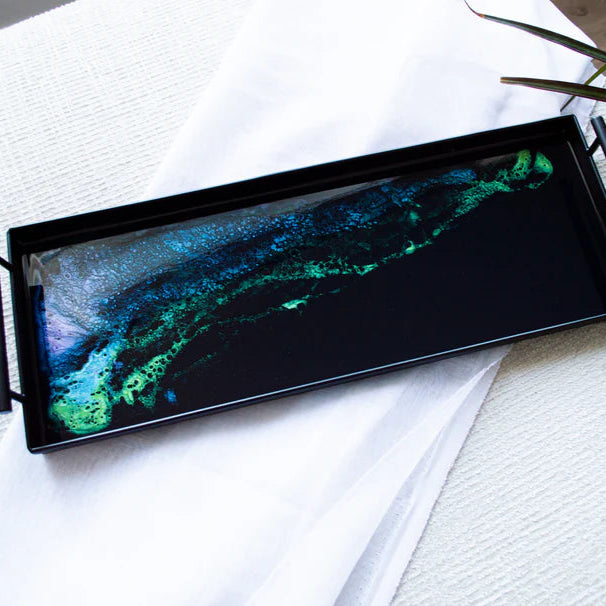 Decorative resin tray with a green and blue abstract design on a white surface