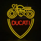 Yellow neon outline of a motorcycle above a yellow shield with red neon text reading 'DUCATI' inside on a black background.