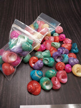 Brightly dyed turbo shells showing spiral patterns in assorted vibrant colors