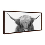 Framed black and white canvas print of a Highland cow with long shaggy hair covering its eyes and wide curved horns against a white background.