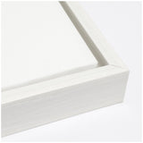 Close-up of a white wooden frame corner with a white canvas stretched tightly inside, highlighting the clean lines and smooth texture of the materials.