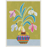 Stylized snowdrop flowers in pink, white, and yellow with blue-green leaves in a colorful geometric patterned vase on a light blue surface and olive background.