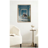Elephant standing inside a corridor with detailed blue arches and sunlight streaming in, shown in a wooden-framed canvas print on a white wall.