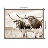 Sepia-toned photograph of two Texas Longhorn cattle standing in a field with tall grass under a cloudy sky, framed with a simple wooden border.