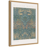 Framed William Morris artwork titled 'Peacock and Dragon' from 1878 showing symmetrical ornamental peacocks and dragons in muted blue and tan tones against a detailed floral background.