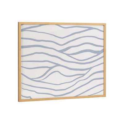 Framed abstract coastal waves print in gold gallery frame on a wall