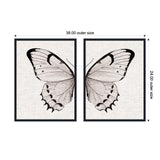Two framed canvases side by side, each showing one half of a minimalist black and white butterfly wing on a textured neutral linen background, composing a full butterfly when joined.