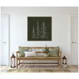 Minimalist sketch of three tall evergreen trees in light green on a dark green framed canvas hanging above a wooden bench with green and white pillows and a potted plant.