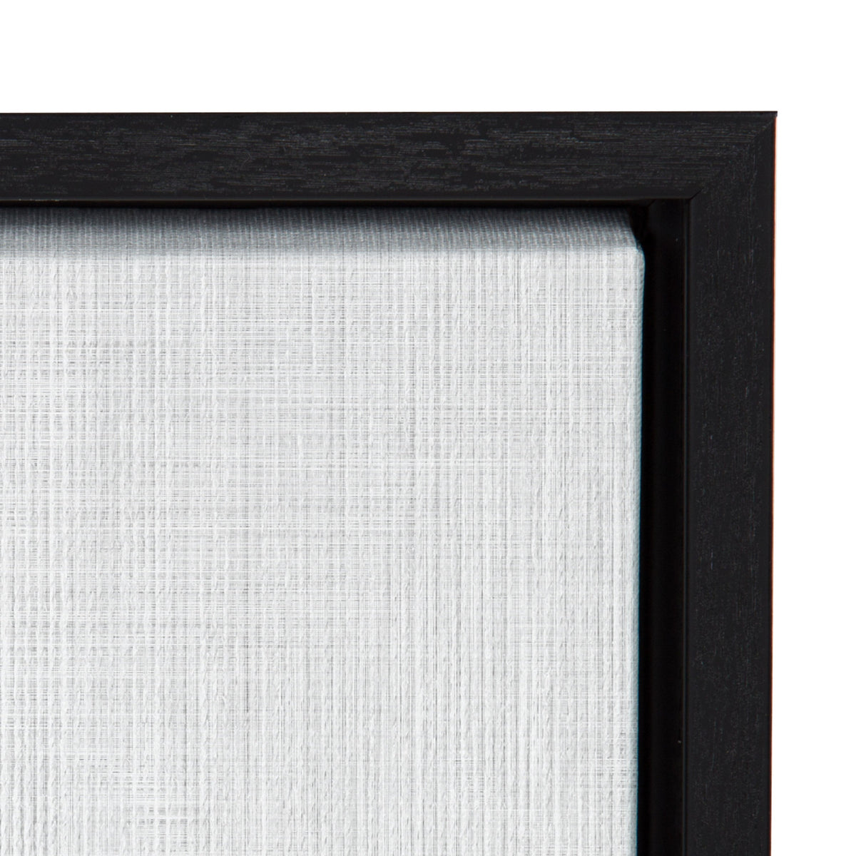 Close-up of white textured canvas corner with a black wooden frame, showing fine linen weave detail and clean mitered joint.