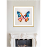 Framed abstract butterfly artwork with bold brushstrokes in blue, orange, pink, and black, hanging above an ornate white fireplace mantel.