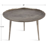 Round metal coffee table with a textured, scalloped edge surface and three slender, tapered legs, finished in a matte gray tone with subtle bronze highlights.