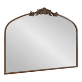 Rectangular arch-top mirror with a bronze frame and ornate floral scroll detail centered on the top edge