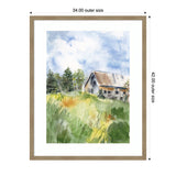 Watercolor painting of a weathered barn with a rust-colored roof surrounded by green grass and trees under a cloudy blue sky, in a simple light wood frame.