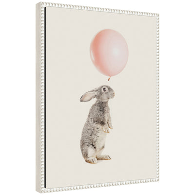 Framed canvas art titled 'Sylvie The Bunny and the Pink Balloon' showing a bunny holding a pink balloon, with a vintage beaded frame