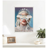 Framed wall art titled Moon Witch depicting a woman with long blonde hair, a large white moth covering her eyes, red lips, a celestial crown, and a star-filled background.