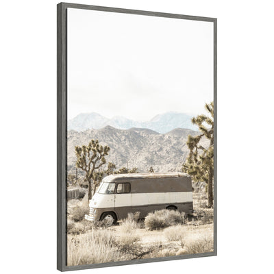 Framed canvas artwork showing a rustic vintage van in a desert landscape with Joshua Tree, by Saint and Sailor Studios.