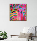 Framed abstract canvas with vibrant brush strokes in pink, red, blue, yellow, and green, depicting curved leaf-like shapes, hanging above a white armchair with beige pillow and gray throw