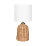 Wylla Rattan Table Lamp with woven rattan base and white linen drum shade on a wooden surface