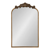 Rectangular wall mirror with an arched top and a carved decorative bronze-toned crest featuring scroll and shell motifs