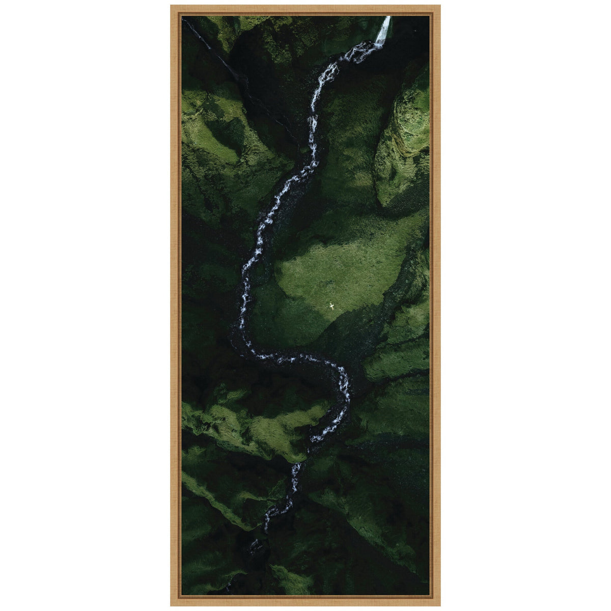 Aerial view of a winding white river cutting through a lush green valley with varying shades of green on moss-covered rocks framed in light wood.