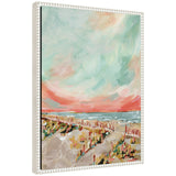 Framed canvas painting showing a beach scene with a pastel sky blending coral, teal, and soft orange hues above a sandy path and wooden fence.