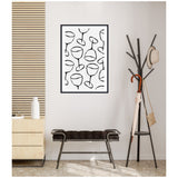 Black and white framed canvas print with abstract line drawings of wine glasses, displayed on a light wall above a dark cushioned bench next to a black metal coat rack.